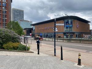 a man standing in front of a building on a street at Broad St 1-Bed Sleeps 2 with Free Parking in Birmingham