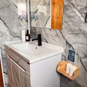 a bathroom with a white sink and a mirror at Ethno complex Ala kush in Kaindy +59 photos