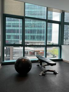 a office with a chair and a large window at Rustic Elegance New One Bedroom One Uptown Free parking in Manila