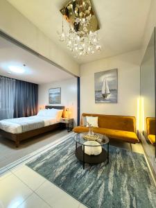 a bedroom with a bed and a couch and a table at Rustic Elegance New One Bedroom One Uptown Free parking in Manila