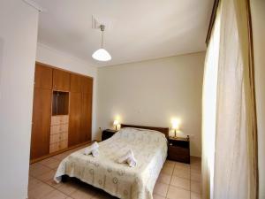 a bedroom with a bed with two towels on it at Myrstia Apartments in Pyrgi Thermis