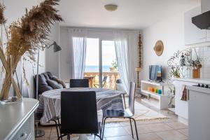 a kitchen and dining room with a table and chairs at Appartement Les pieds dans l eau in Hyères +36 photos
