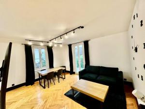 a living room with a couch and a table at Cosy apartment in Lausanne in Montagibert +22 photos