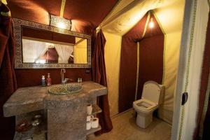a bathroom with a sink and a toilet at Dunes Berber Camp in Merzouga