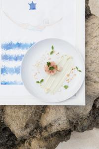a plate of food sitting on a table at Pagoda Lifestyle Hotel in Ischia +37 photos