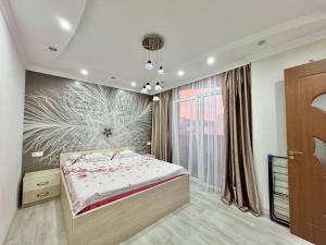 a bedroom with a bed and a window at Apartment Rimma in Batumi +52 photos
