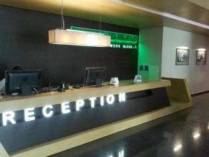 a reception desk with a sign that reads reception at Apartment Rimma in Batumi