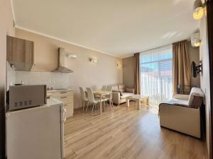 a living room with a kitchen and a dining room at Apartment Rimma in Batumi