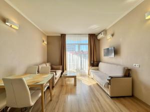 a living room with a table and a couch at Apartment Rimma in Batumi