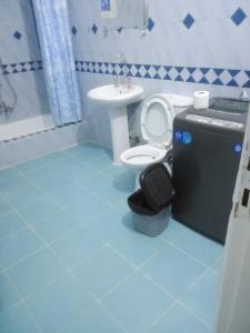 a blue bathroom with a toilet and a sink at Nubian Life Nile View in Aswan +210 photos