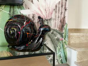 a black motorcycle helmet sitting on top of a glass table at Villa Canepa in Marsala