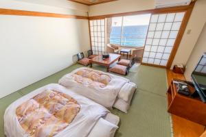 Voodi või voodid majutusasutuse Atagawa Onsen Blue Ocean toas