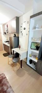 a kitchen with a white table and chairs in a room at Staycation in Quezon City in Manila