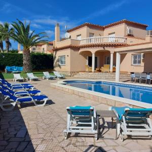 a villa with a swimming pool and lounge chairs at Buena Vista in L'Ametlla de Mar +55 photos
