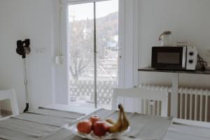 a kitchen with a table with a bowl of fruit on it at Ferienwohnung Maria in Herten +5 photos