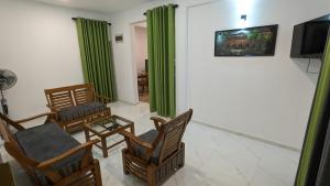 a living room with chairs and a flat screen tv at Star Beach Villa in Tangalle