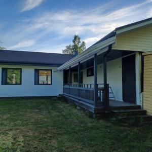 a house with a large porch with a deck at Villa Finlandia, Tornio at the border of Finland and Sweden in Tornio