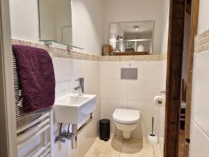 a white bathroom with a sink and a toilet at Couples Gem - Sensational views Nr Morzine in La Côte dʼArbroz +45 photos