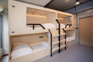 a bunk bed room with three bunk beds in it at DMK Place in Bangkok