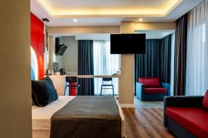 a hotel room with a bed and a living room at Lucky Monkey Midi Hotel in Antalya