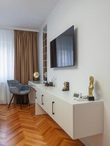 a living room with a tv on a wall at MSC Apartment in Sibiu