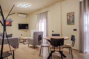 a living room with a table and chairs at City Lodge in Thessaloniki