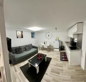 a living room with a couch and a table at Cosy citadin in Mulhouse