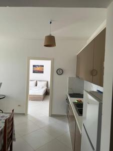 a kitchen with a table and a room with a couch at Natali Apartments in Gjilek