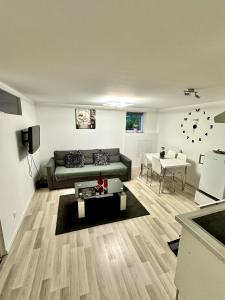 a living room with a couch and a table at Cosy citadin in Mulhouse