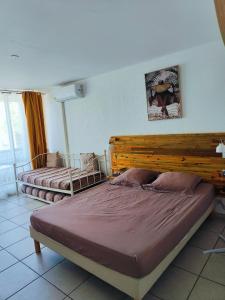 a bedroom with two beds in a room at Studio West-indies résidence Savane et Archipel in Le Gosier +28 photos