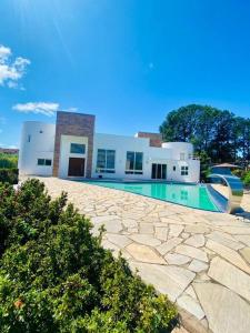 a house with a swimming pool in front of it at Casa-Condomínio-Itu-City Castelo in Itu
