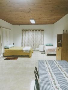 a room with two beds and two chairs in it at La Casita del Molino in Trevelin +33 photos
