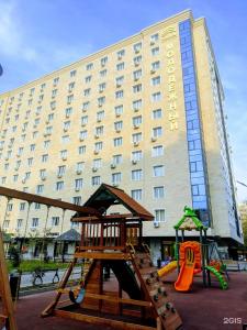 a playground in front of a large building at Premium Residence, steps to center Arbat, drinking water as a gift in Almaty