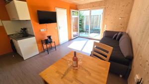 a living room with a couch and a table at Natur Apartments Natalia in Fürth +2 photos