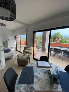 a living room with a table with a laptop on it at Penthouse Palapagolf in Orihuela Costa