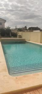 a swimming pool with blue water in front of a building at Villa Kathy in Los Altos