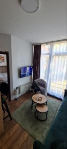 a living room with a couch and a table at Apartman Djurdja in Divčibare