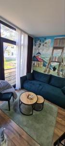 a living room with a blue couch and a table at Apartman Djurdja in Divčibare