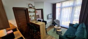 a living room with a blue couch and a table at Apartman Djurdja in Divčibare