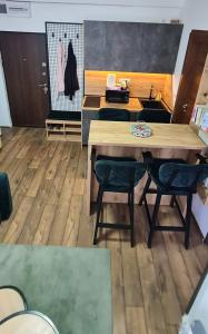 a dining room with a wooden table and chairs at Apartman Djurdja in Divčibare