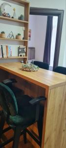 a wooden desk with a black chair and a table at Apartman Djurdja in Divčibare
