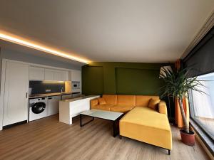 a living room with a couch and a table at OTTO Tunalı Houses in Ankara