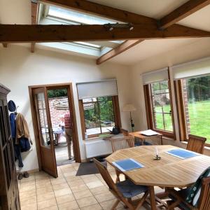 a living room with a wooden table and chairs at Les Ruisseaux in Gedinne +28 photos