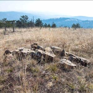 a pile of rocks in the middle of a field at Apartman Djurdja in Divčibare