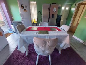 a dining room table with a white table and chairs at Single guest room in Walsall in Bloxwich