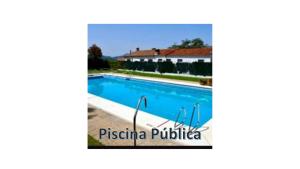 a swimming pool in front of a villa at Casa Perejil, un balcón al Genal in Genalguacil