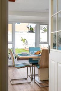 a dining room with a table and chairs and a table at Home in Patchway in Bristol