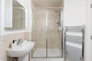 a bathroom with a shower and a sink and a mirror at Home in Patchway in Bristol +14 photos