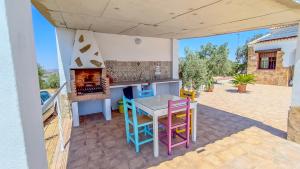 eine Küche mit Tisch und Kamin auf einer Terrasse in der Unterkunft Villa 62 by Villamya in El Gastor
