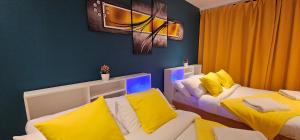 a room with two beds with yellow pillows at Glamorous Apartment at Christchurch Park in Ipswich +30 photos